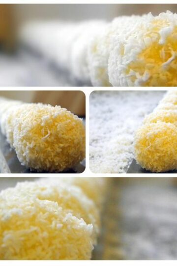 Petites boules à la noix de coco enrobées de noix de coco râpée, prêtes à être dégustées.